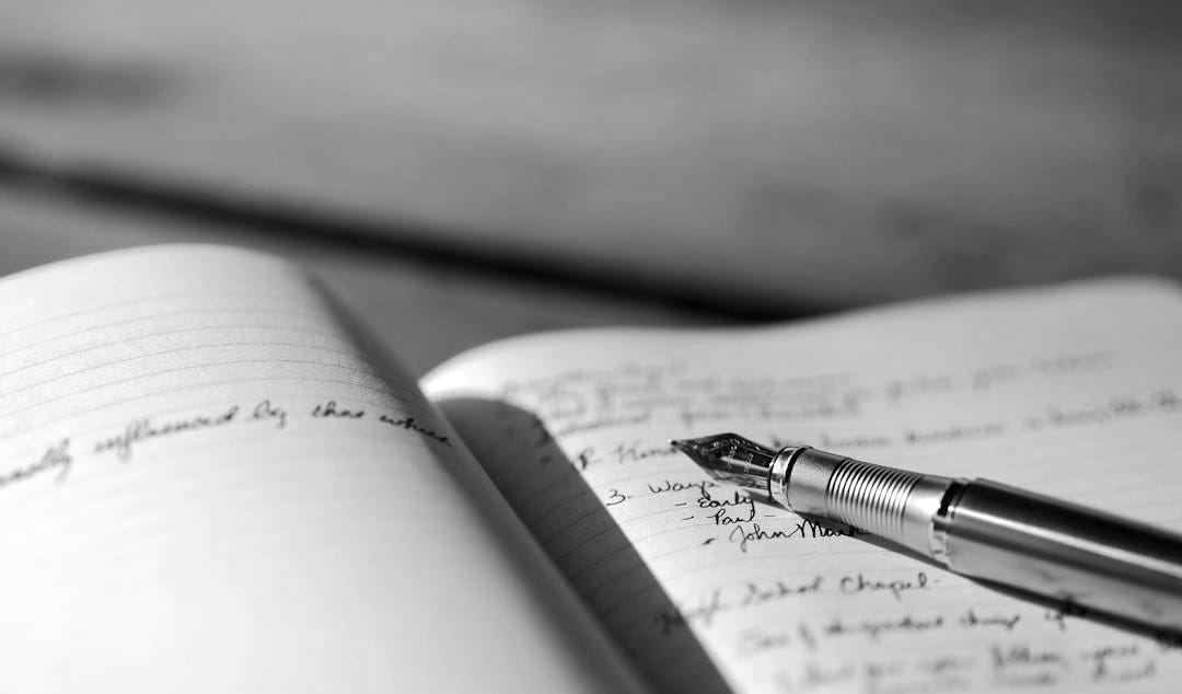 pen on white lined paper selective focus photography