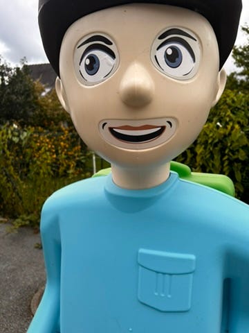 A plastic toy figure with a cartoon face

Description automatically generated