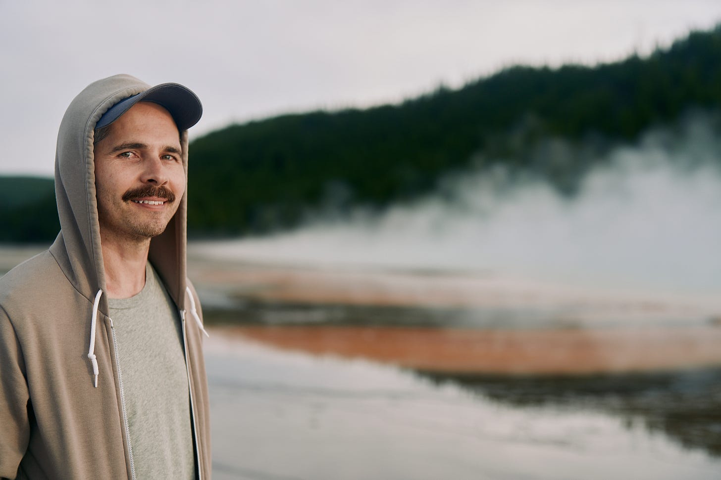 Portrait of Timmy in front of one of the largest volcanic hot springs in Yellowstone National Park.