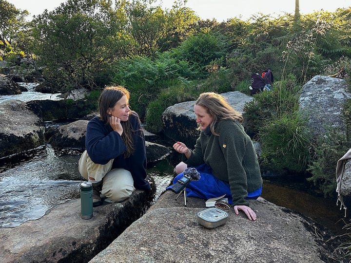 L - R: Two women hiking along a coastal path with the ocean to one side. A group of people standing on a street listening to a man speaking, while a cameraman is filming him, cloudy Table Mountain is in the background. A fireplace with lit candles in the centre, decorated with flower arrangements, other objects and photos of foremothers. Post-its and a sketch of Foregather’s creative energy model are stuck to the fireplace.