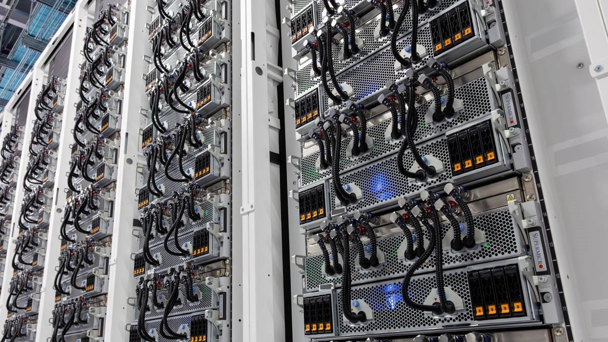 Four banks of xAI's HGX H100 server racks, holding eight servers each.