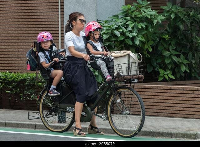 Japanese mothers riding mamachari utiity bicycle in Tokyo street, Japan  Stock Photo - Alamy