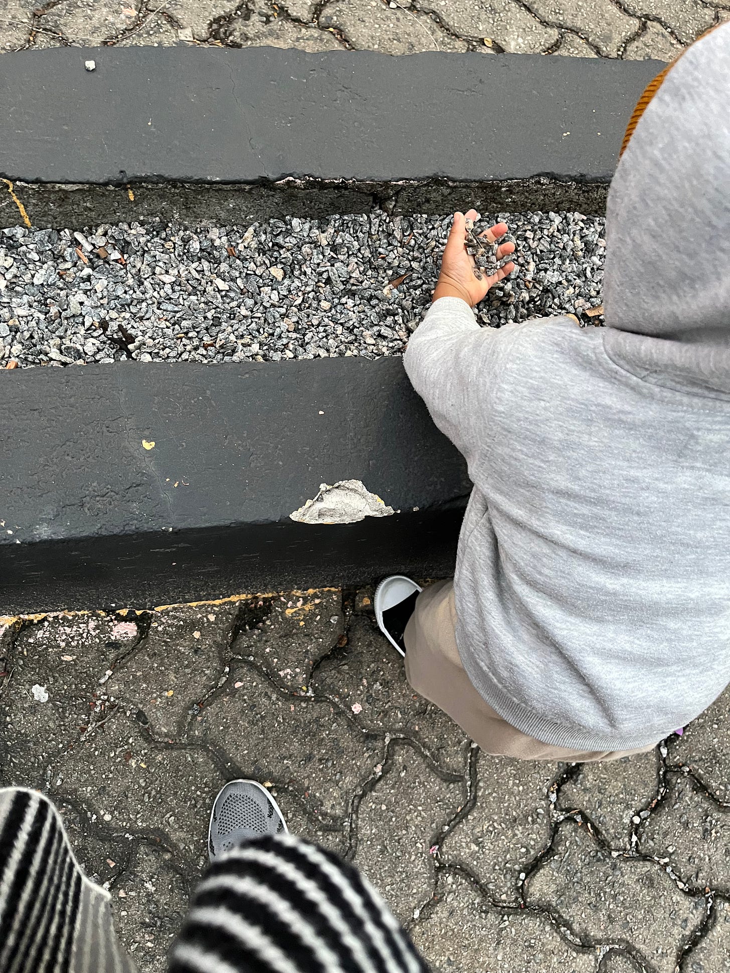 Boy toddler playing with stones
