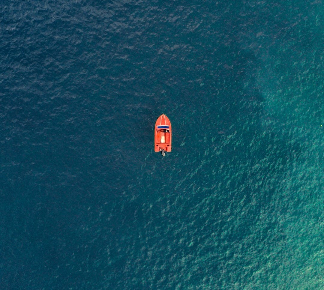 An aerial view of a boat in the ocean