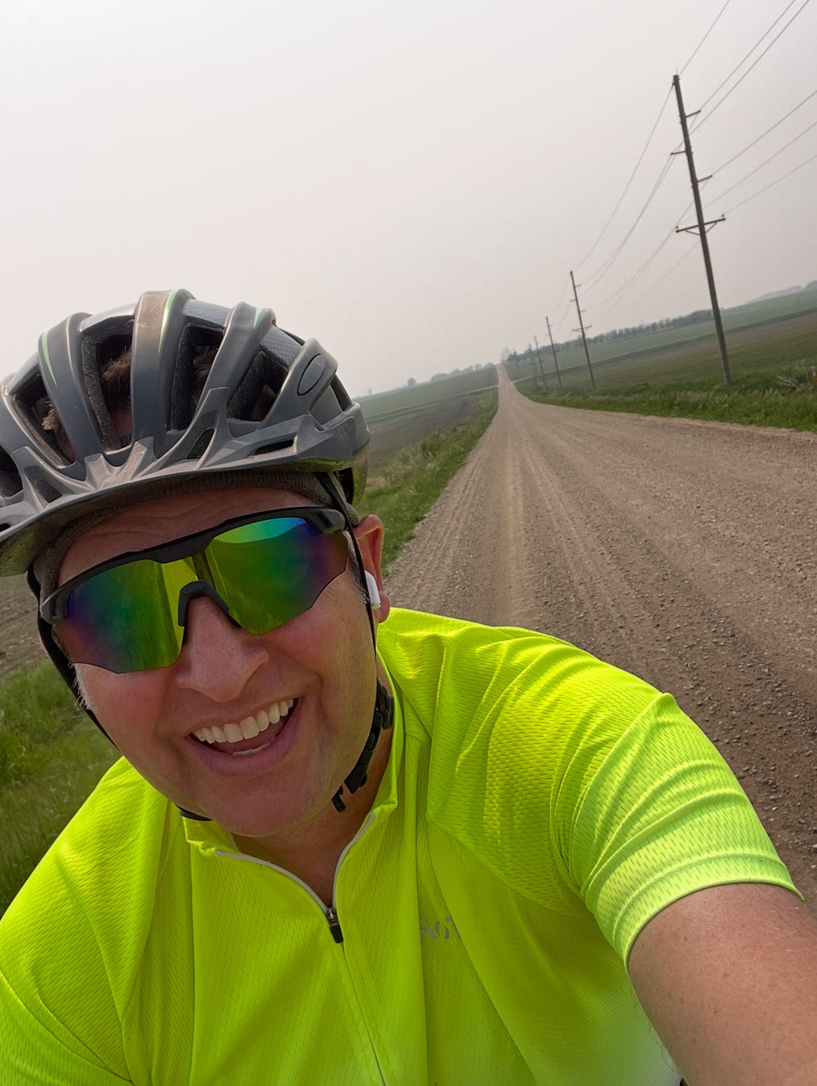 A selfie of Dr. Dave pedaling his bike on a gravel road in northwest Iowa