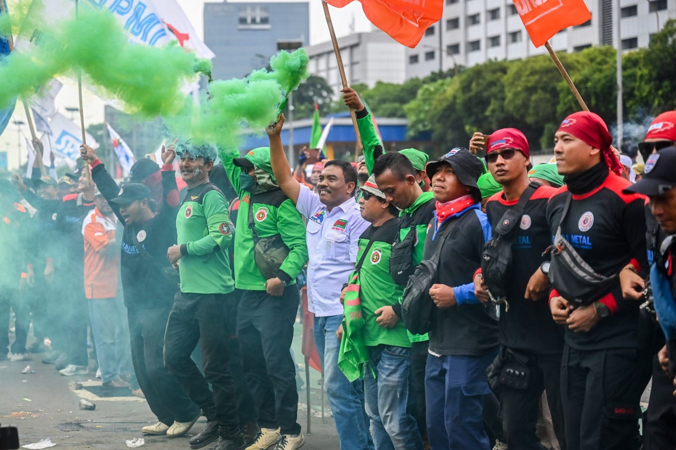 Workers participate on a rally in front of the Senayan legislative complex in Jakarta on Aug. 28, 2025. During the protest, laborers demand a revision to the labor regulations and ways to ensure better work protection across the country. 