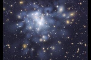 This NASA Hubble Space Telescope image shows the distribution of dark matter in the center of the giant galaxy cluster Abell 1689, containing about 1,000 galaxies and trillions of stars. Dark matter is an invisible form of matter that accounts for most of the universe’s mass. Hubble cannot see the dark matter directly. Astronomers inferred its location by analyzing the effect of gravitational lensing, where light from galaxies behind Abell 1689 is distorted by intervening matter within the cluster. Researchers used the observed positions of 135 lensed images of 42 background galaxies to calculate the location and amount of dark matter in the cluster. They superimposed a map of these inferred dark matter concentrations, tinted blue, on an image of the cluster taken by Hubble’s Advanced Camera for Surveys. If the cluster’s gravity came only from the visible galaxies, the lensing distortions would be much weaker. The map reveals that the densest concentration of dark matter is in the cluster’s core. Abell 1689 resides 2.2 billion light-years from Earth. The image was taken in June 2002. Image credit: NASA, ESA, D. Coe (NASA Jet Propulsion Laboratory/California Institute of Technology, and Space Telescope Science Institute), N. Benitez (Institute of Astrophysics of Andalusia, Spain), T. Broadhurst (University of the Basque Country, Spain), and H. Ford (Johns Hopkins University)