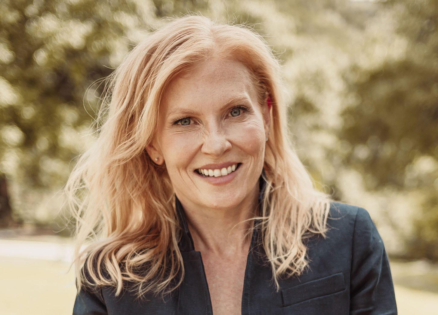 A headshot of journalist Ana Marie Cox standing outside 