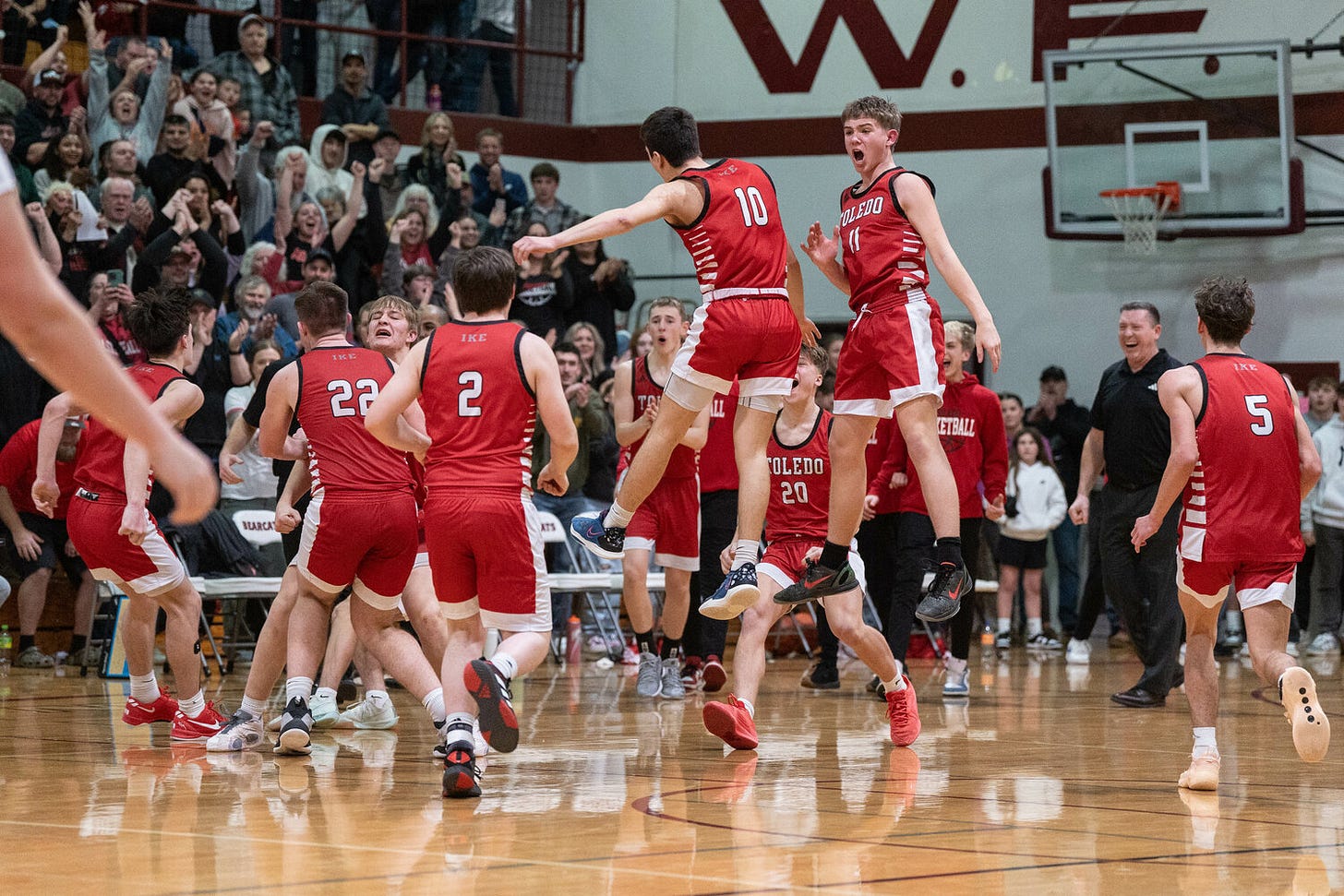 Toledo players celebrate after a 60-59 overtime 2B District 4 Championship win over Adna at W.F. West High School in Chehalis on Saturday, Feb. 22.