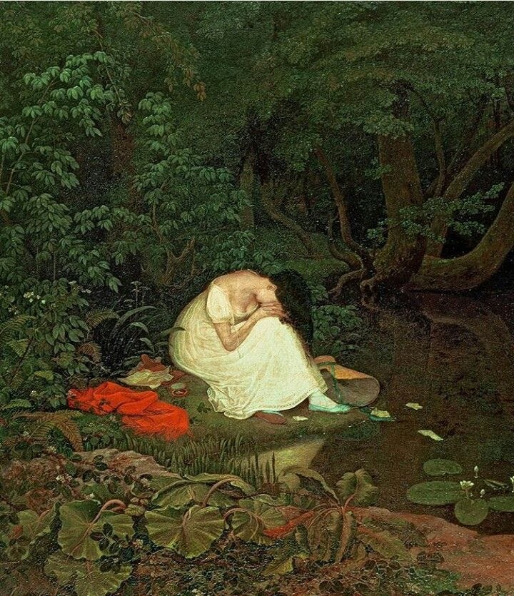 This may contain: an image of a woman laying on the ground with her head in her hands, surrounded by water lilies