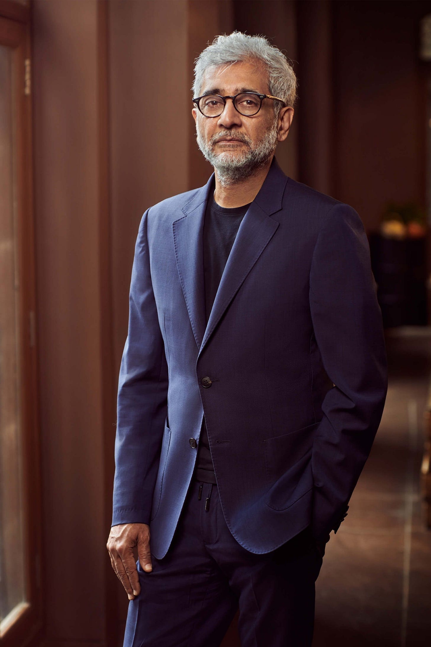 Image may contain Saeed Jalili Blazer Clothing Coat Jacket Formal Wear Suit Adult Person Accessories and Glasses