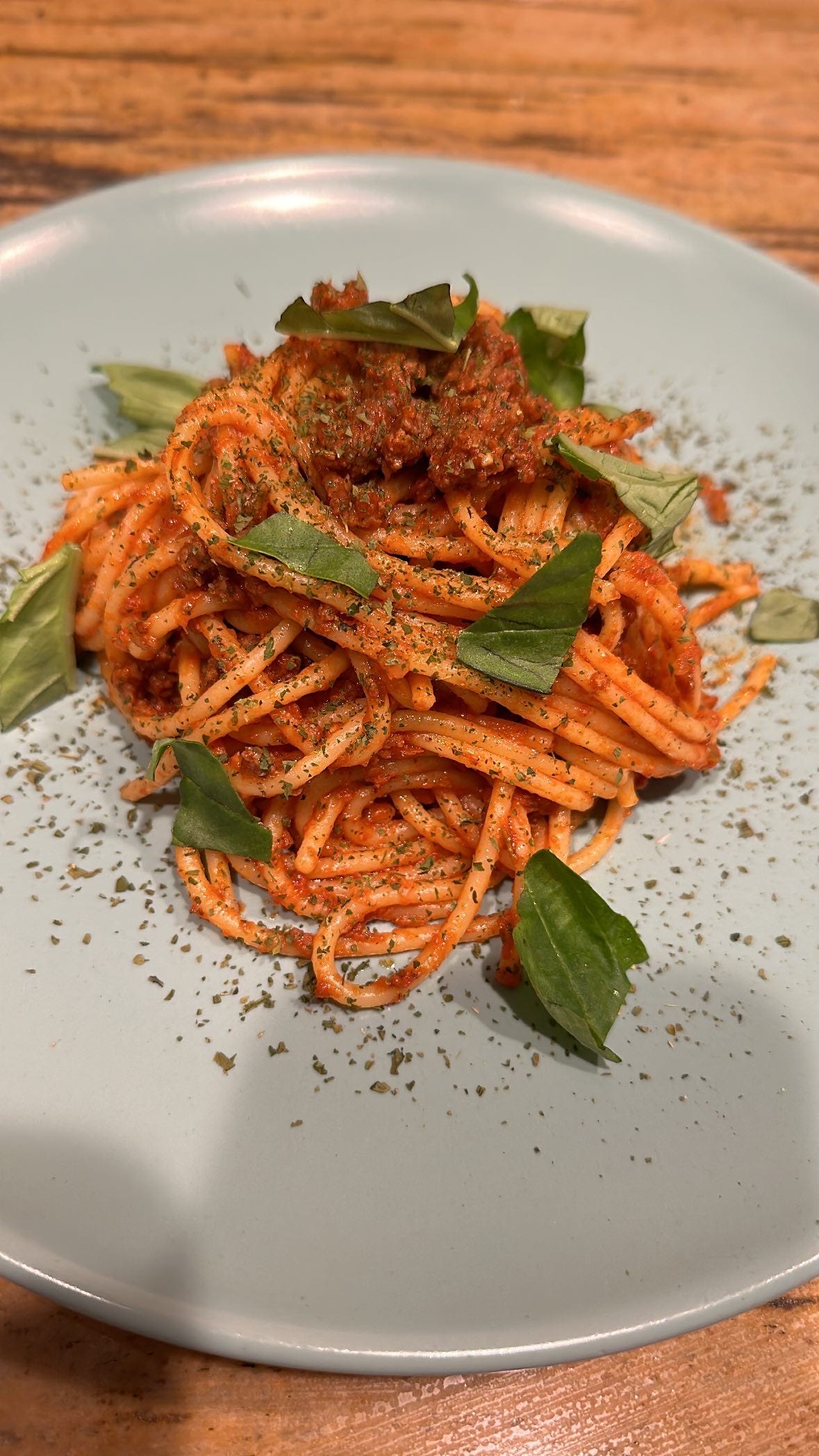 Picture of spaghetti bolognese with basil.