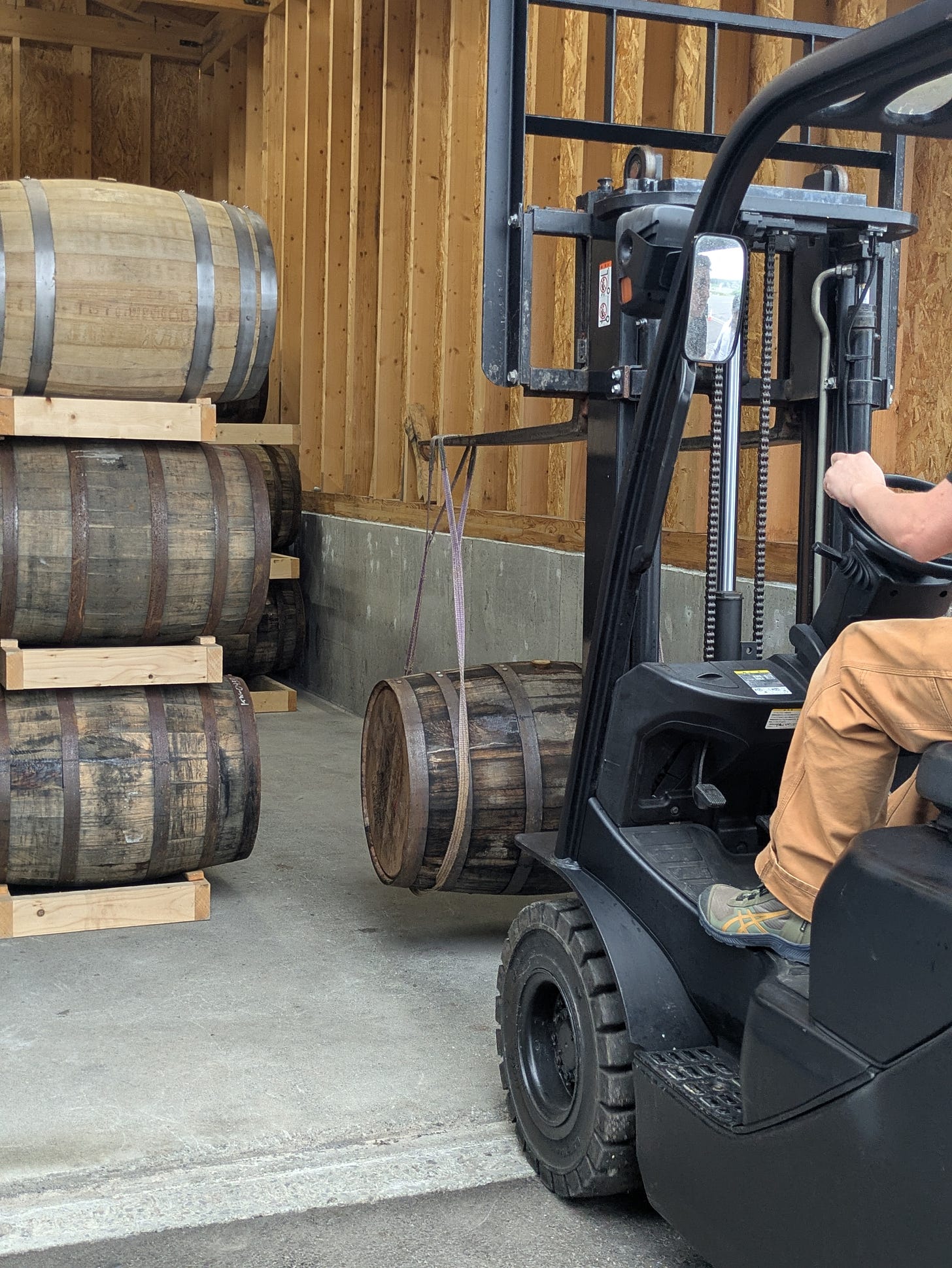 Kamui Whisky K.K. Black Forklift Placing Whisky Barrel with Rope