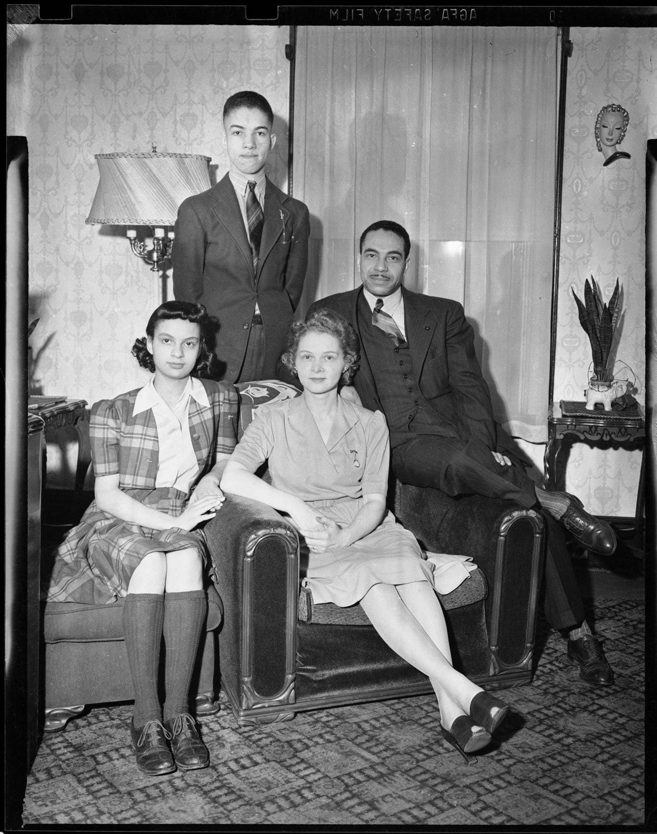 A rare and poignant family photo of a mixed couple in Pittsburgh, captured on an Agfa negative in the 1940s.
