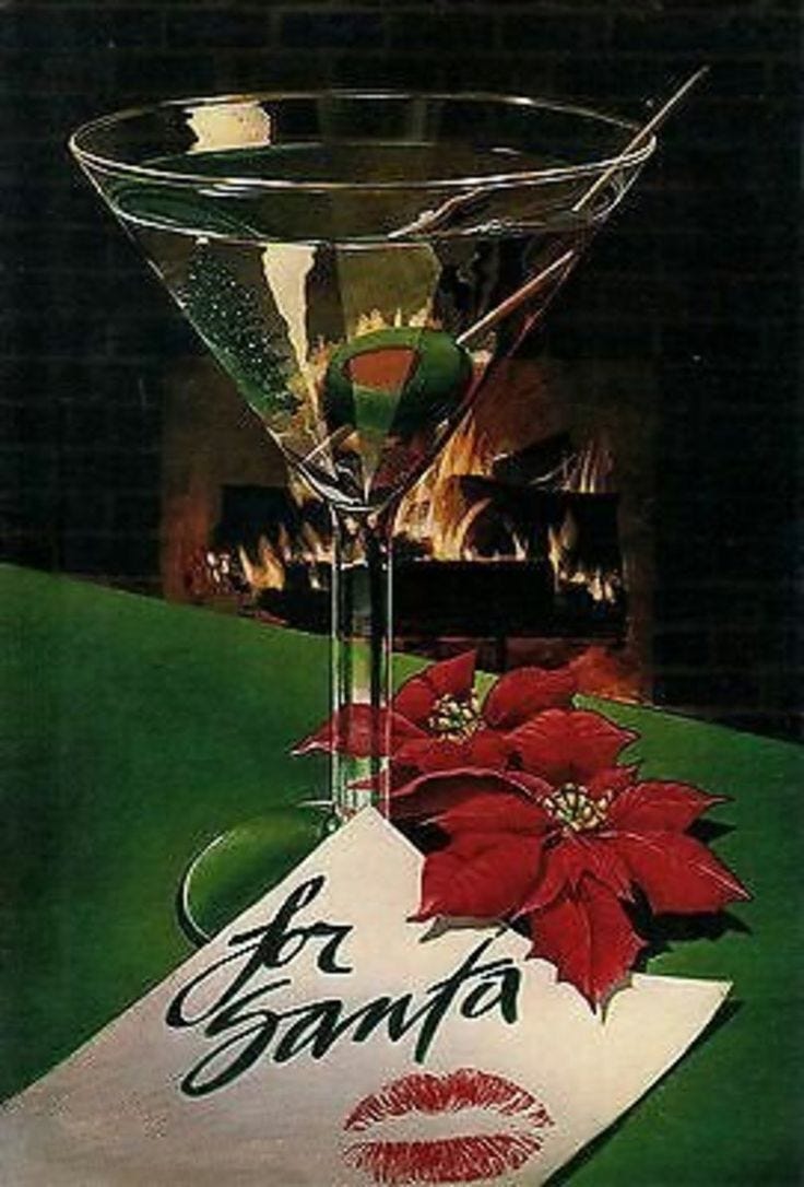 This may contain: a martini glass sitting on top of a table next to a napkin with red poinsettis