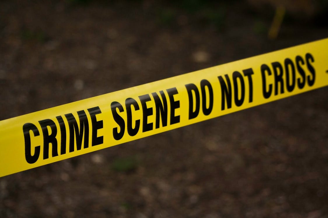 Free Close-up of crime scene tape with 'Do Not Cross' text, outdoors setting. Stock Photo Free Close-up of crime scene tape with 'Do Not Cross' text, outdoors setting. Stock Photo