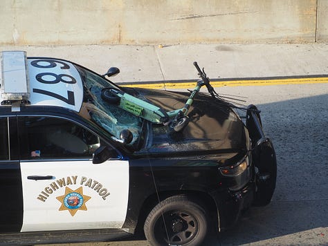 Protesters begin vandalizing police vehicles that are parked on the 101 freeway.