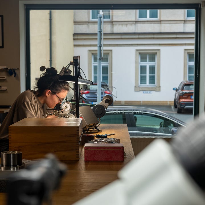 Two watchmakers finishing components at Kallinich Claeys