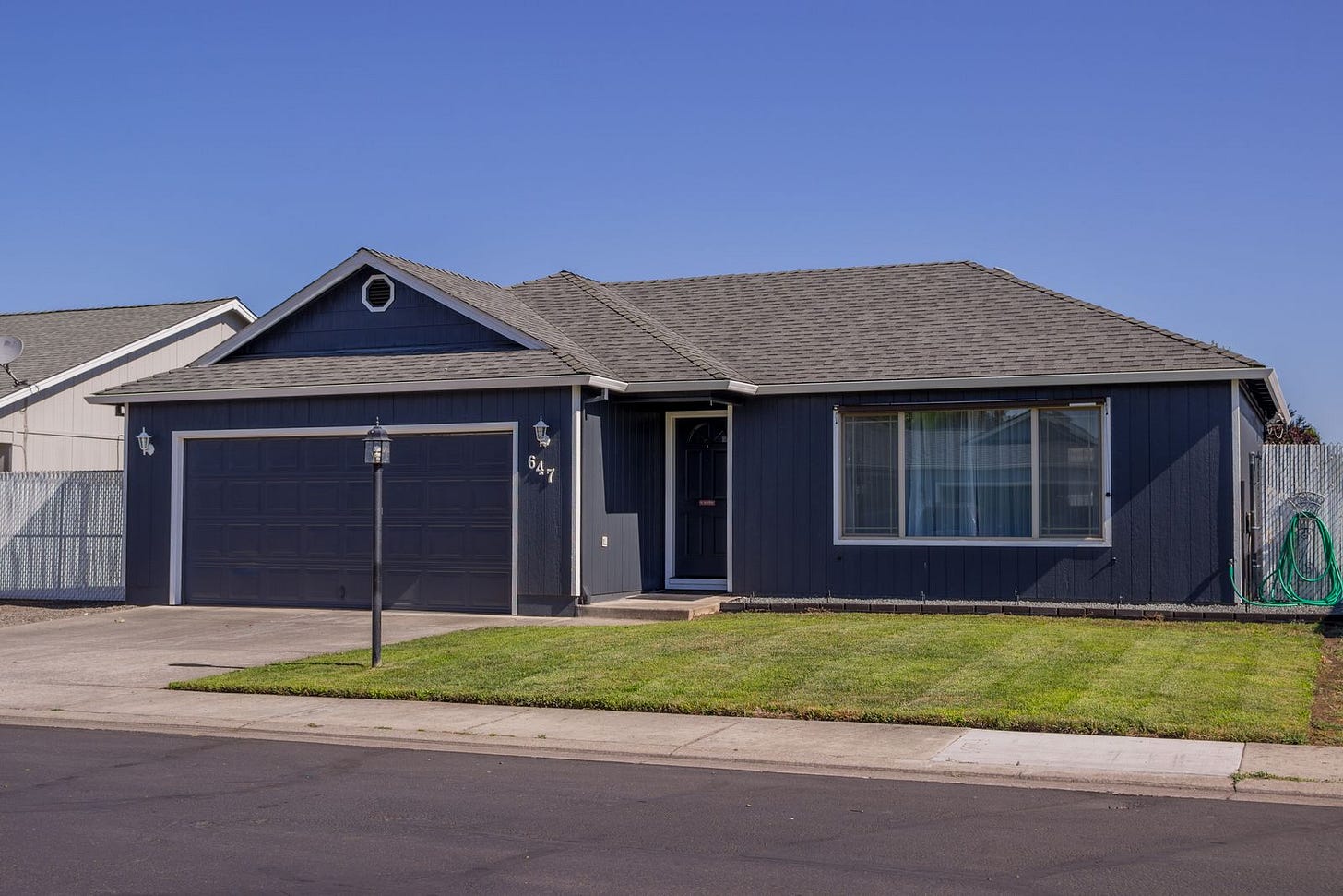 Ordinary single story house with an empty driveway, typical of an inherited Texas property Ordinary single story house with an empty driveway, typical of an inherited Texas property