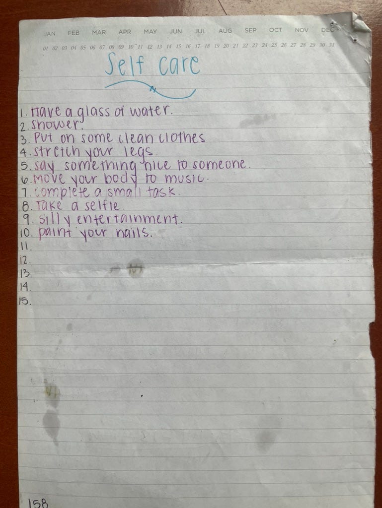 A bare bones self-care list handwritten in purple ink on a piece of lined, stained paper.