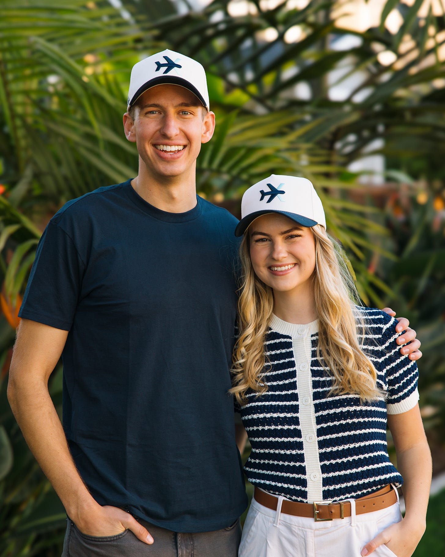 Trent and Bethany, posing with Cross Exchange hats.