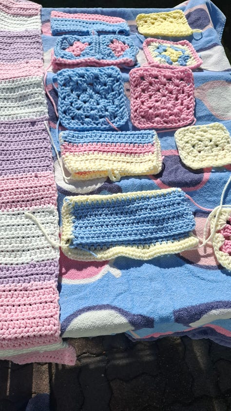 yellow bookmark, pile of crocheted items, rainbow book cozy, yellow pocket, blue coaster, set of pockets