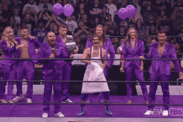 a man in a white apron stands in a wrestling ring with a tbs logo behind him a man in a white apron stands in a wrestling ring with a tbs logo behind him