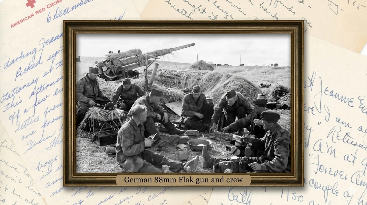 Black and white WWII photograph showing German soldiers eating a meal near their camouflaged 88mm Flak anti-aircraft gun in a field position. The large gun barrel extends over straw camouflage netting while approximately eight crew members sit on the ground with mess kits and equipment.