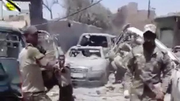 This photo made from undated video posted online shows a man in an Iraqi Army uniform moments before shooting an unarmed ... This photo made from undated video posted online shows a man in an Iraqi Army uniform moments before shooting an unarmed ...