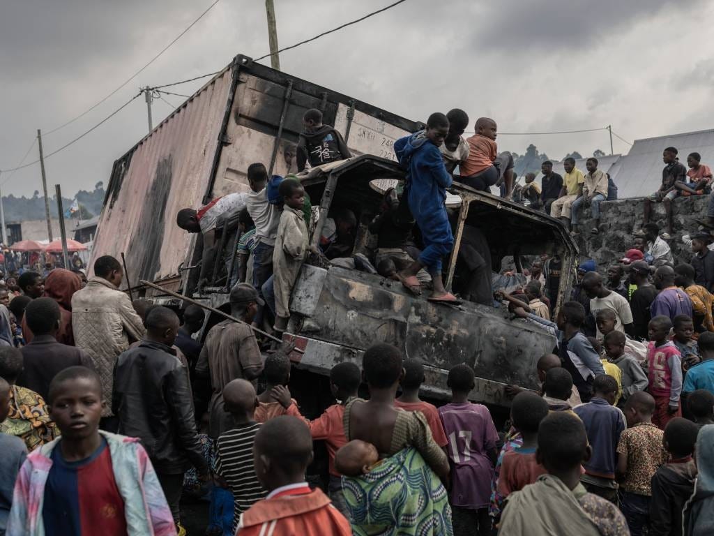 Residents dismantle a vehicle belonging to the Uni