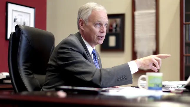 Sen. Ron Johnson seated at his desk, pointing as he speaks Sen. Ron Johnson seated at his desk, pointing as he speaks