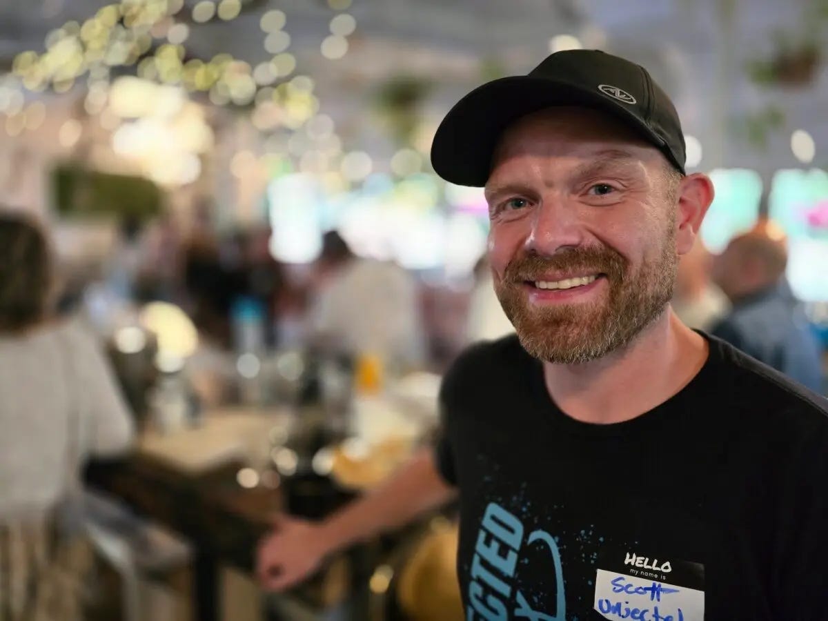 Unjected.com marketing director Scott Armstrong checks in guests during a social mixer for unvaccinated singles in Phoenix, Ariz., on July 15, 2024. (Allan Stein/The Epoch Times) Unjected.com marketing director Scott Armstrong checks in guests during a social mixer for unvaccinated singles in Phoenix, Ariz., on July 15, 2024. (Allan Stein/The Epoch Times)