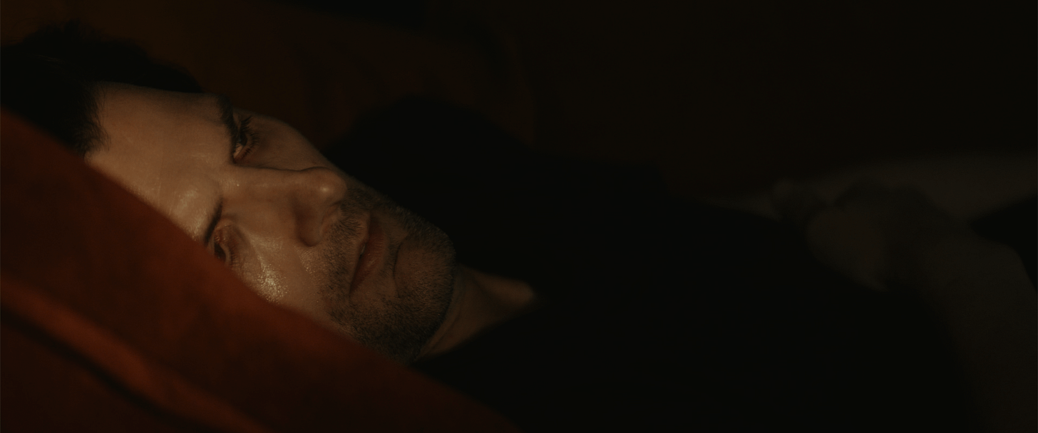 Mark waking back up after passing out from the reintegration process. The lighting on him is warm