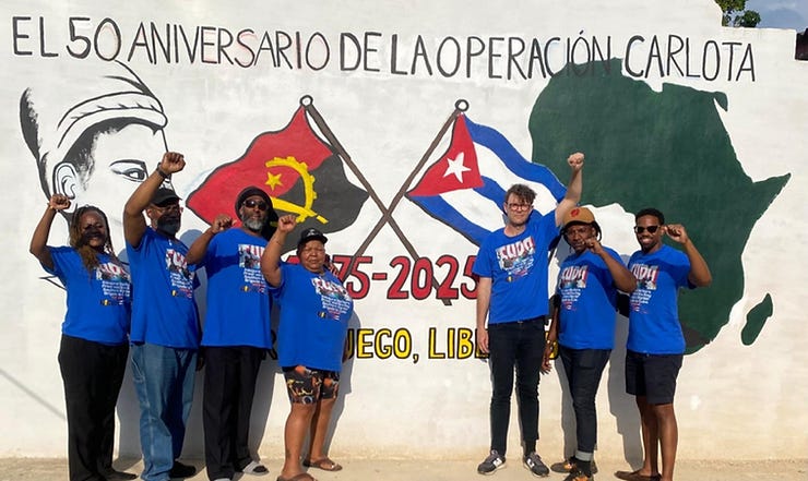 UE150 members in front of newly painted mural at the camp celebrating 50 years since the successful Carlota Operation, when Cuba sent military personnel and tanks to help liberate Angola from apartheid South Africa in 1975.
