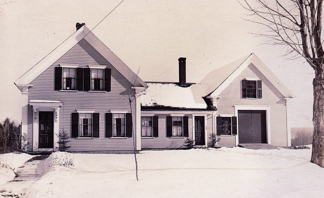 Home and attached barn with snow on ground