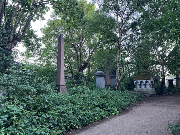 Obelisk grave monuments in an overgrown cemetery