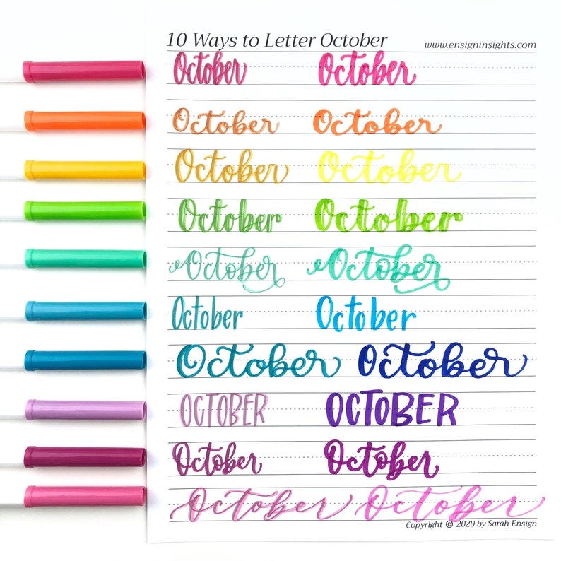 May include: 10 different ways to letter the word "October" in cursive, written in colorful marker on a lined sheet of paper.  The word "October" is written in a variety of styles, including script, calligraphy, and block lettering.