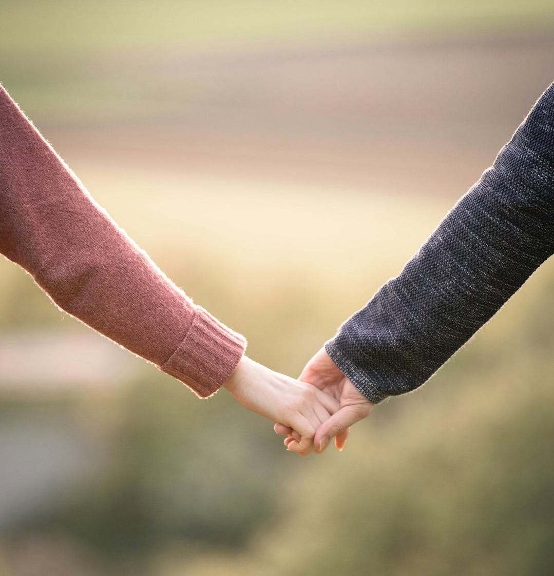 a man and woman holding hands