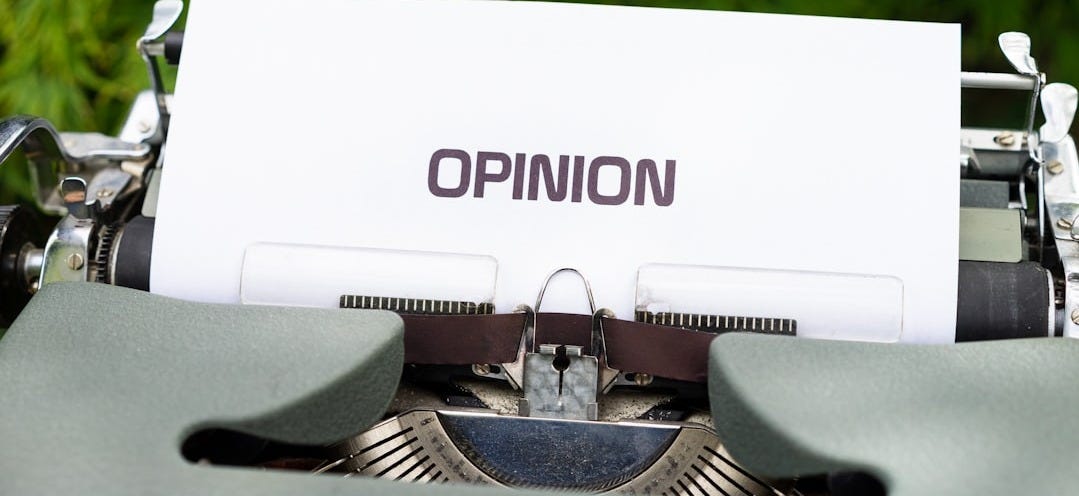 white and black typewriter on green grass during daytime white and black typewriter on green grass during daytime