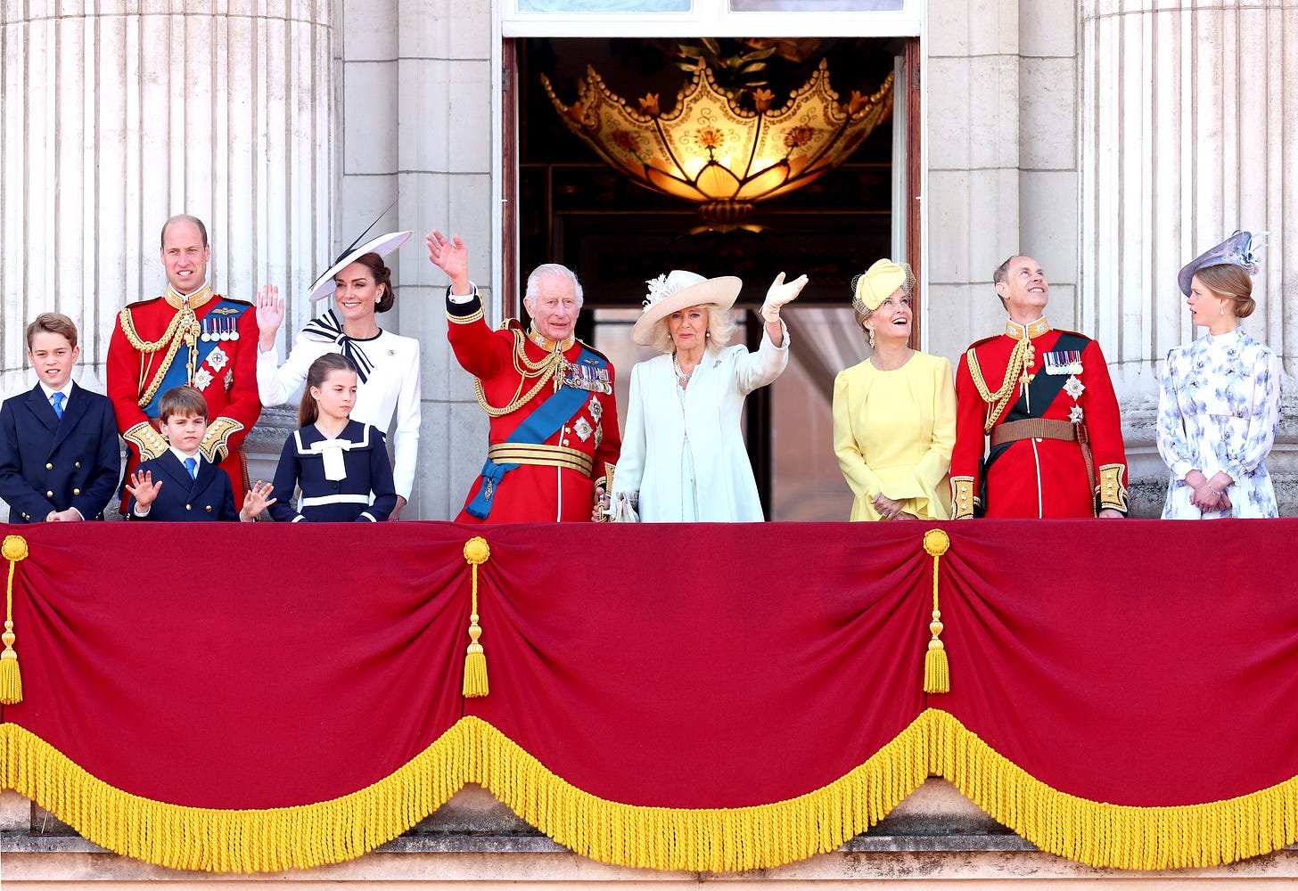 The British Royal Family waving from the Buckingham Palace balcony all dressed formally The British Royal Family waving from the Buckingham Palace balcony all dressed formally