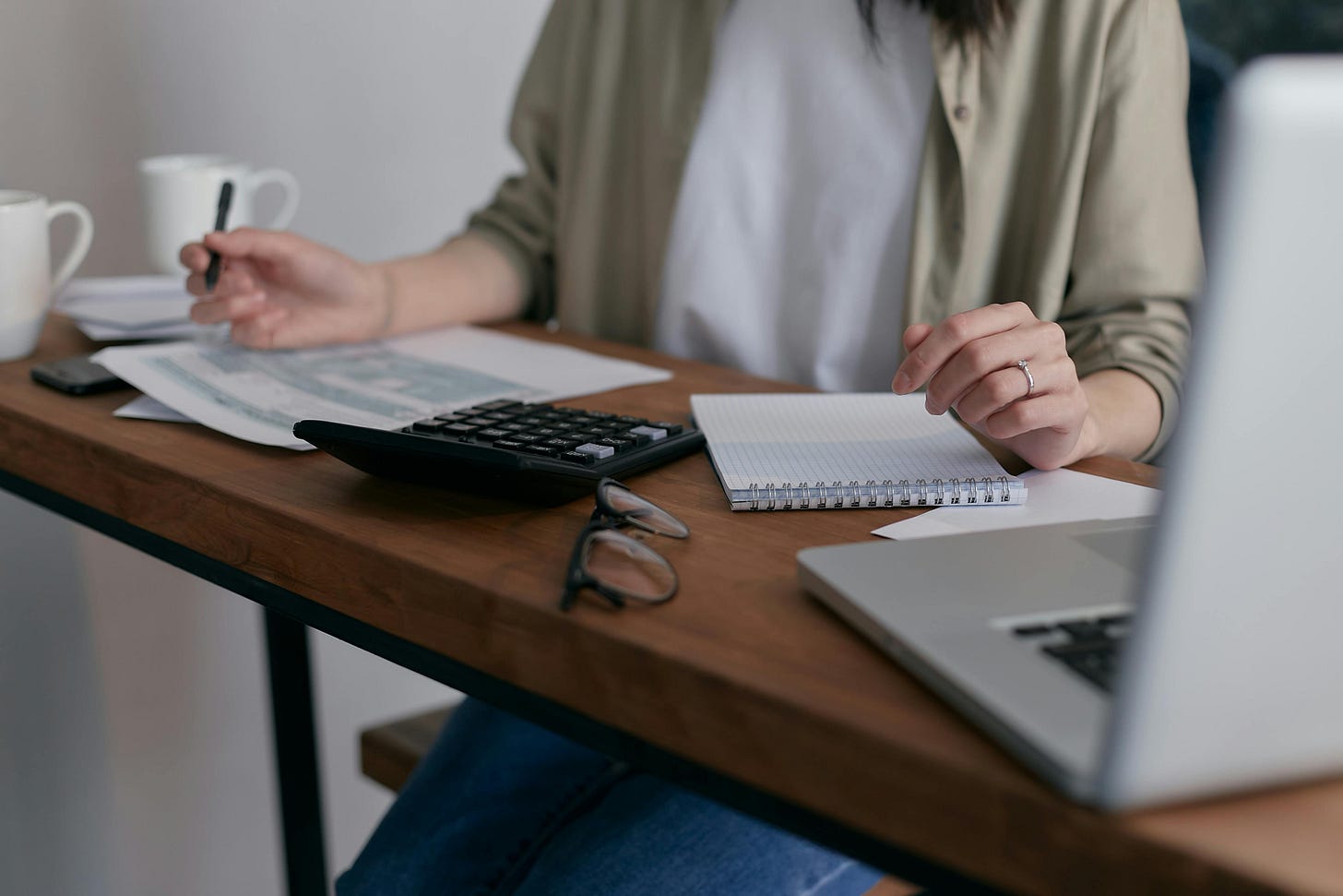 Woman working on paperwork at her computer