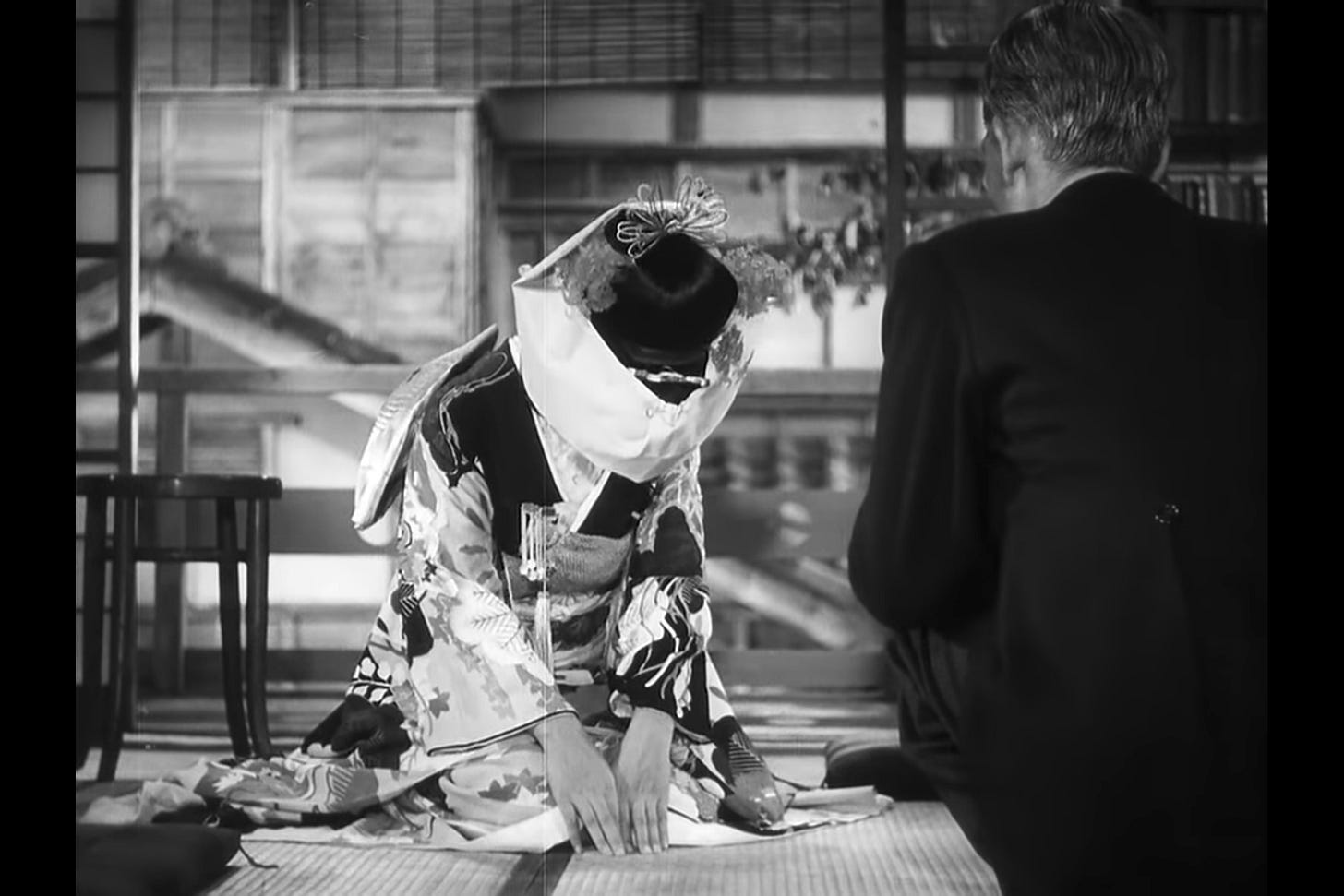 Beyond Ceremony: Noriko, beautifully dressed in a traditional wedding kimono, kneels and bows to her father to thank him for his care, just before she departs for the wedding. Beyond Ceremony: Noriko, beautifully dressed in a traditional wedding kimono, kneels and bows to her father to thank him for his care, just before she departs for the wedding.