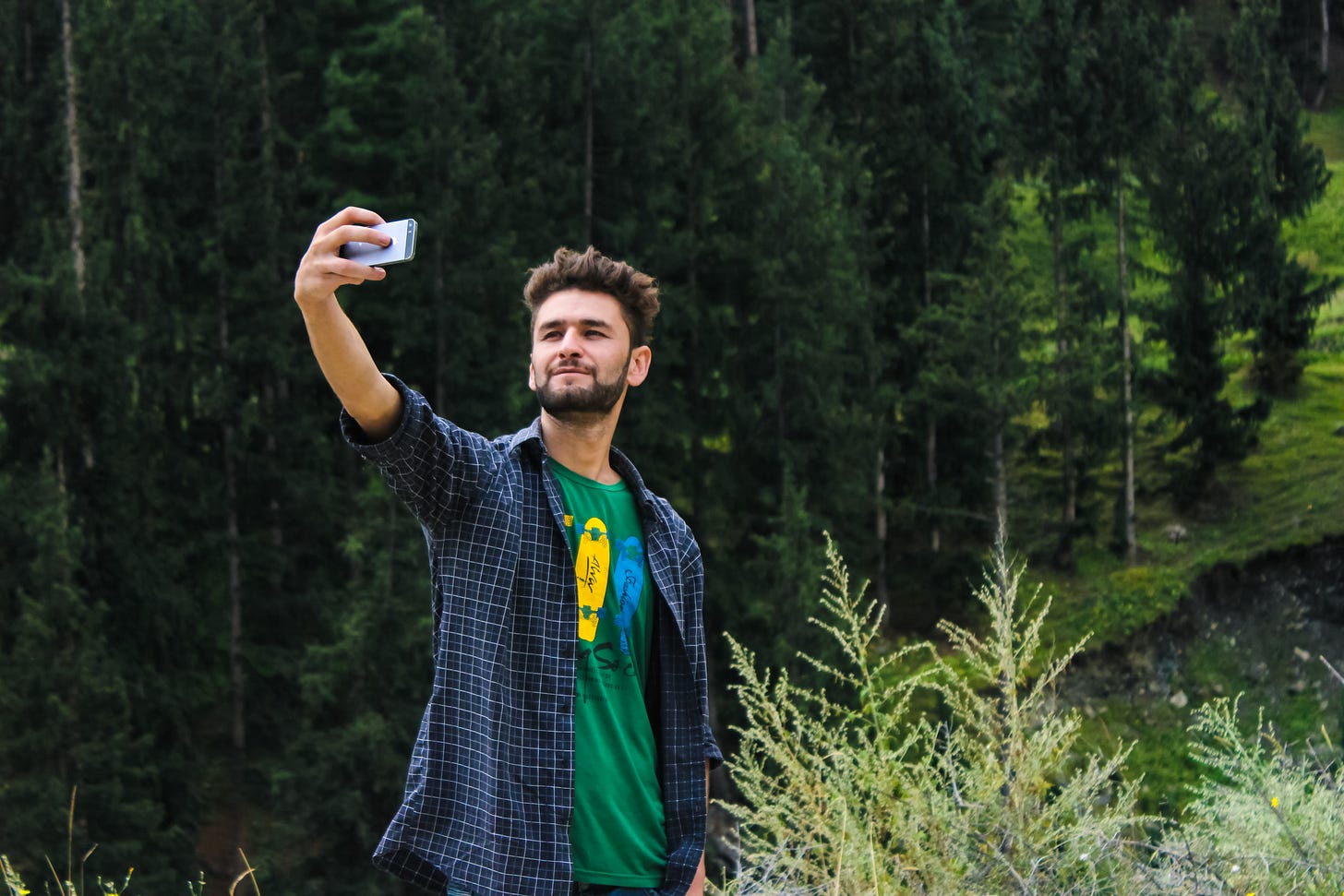 Free Man in Blue Sports Shirt and Green Top Taking a Selfie Near Green Trees Stock Photo Free Man in Blue Sports Shirt and Green Top Taking a Selfie Near Green Trees Stock Photo