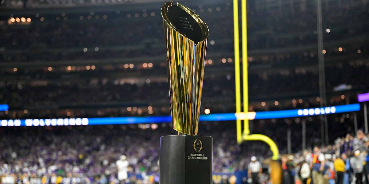 Image of the CFP championship trophy on the field in Houston before Michigan's 2024 national title win over Washington. Deals on seats, fan gear, and premium college football coverage from www.NattyRoad.com Image of the CFP championship trophy on the field in Houston before Michigan's 2024 national title win over Washington. Deals on seats, fan gear, and premium college football coverage from www.NattyRoad.com