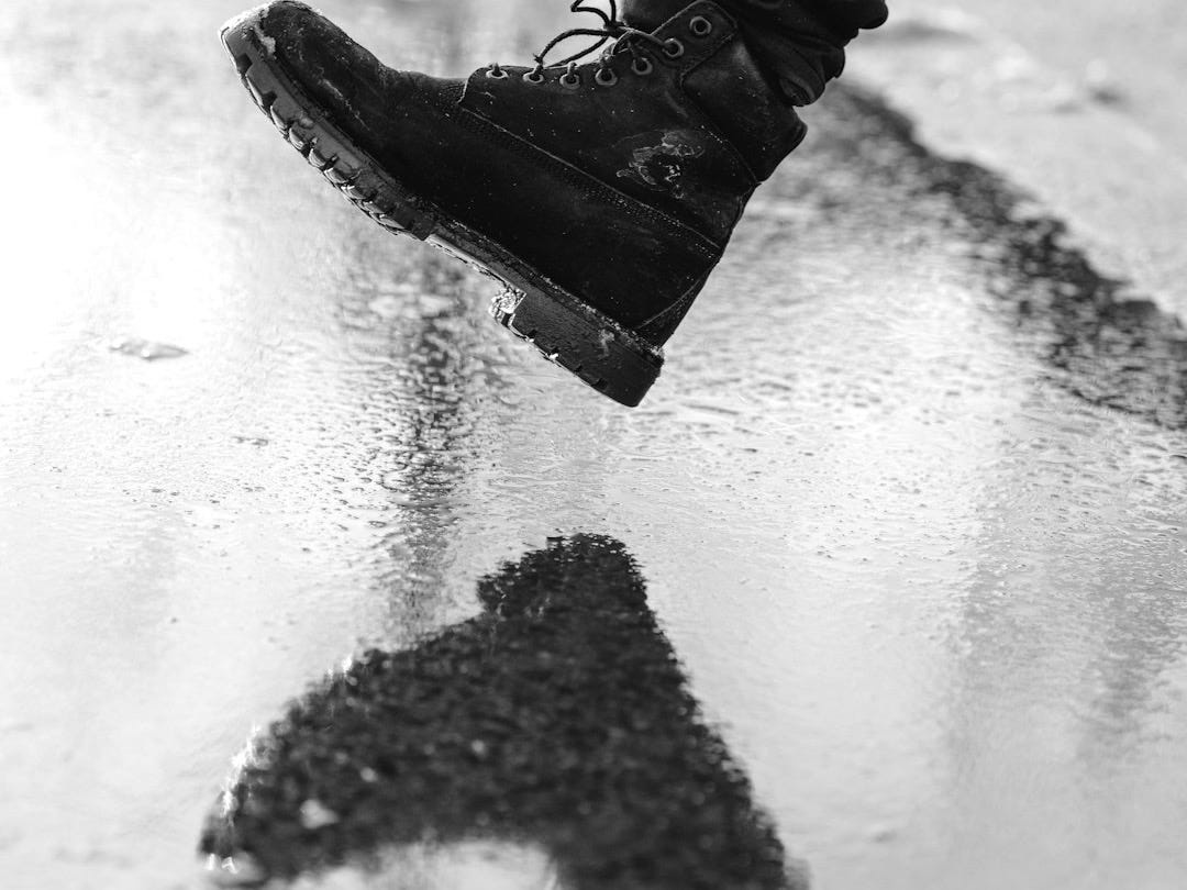a person standing on top of a puddle of water