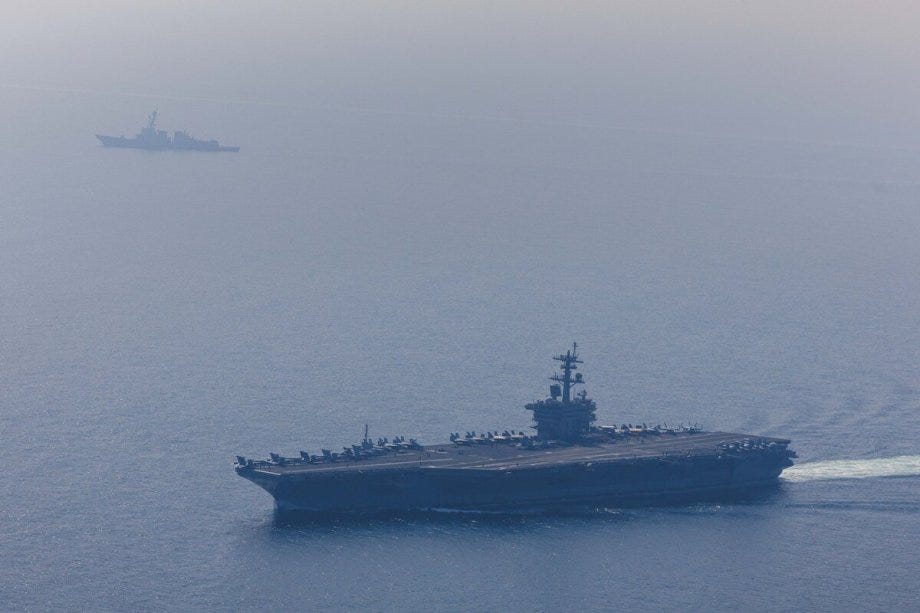 An aerial view of the USS Abraham Lincoln Carrier Strike Group while operating at the Arabian Sea, escorted by two military replenishment ships and two U.S. Coast Guard vessels, as fighter jets from Carrier Air Wing Nine conducted flight operations overhead in the Arabian Sea, on February 6, 2026. [US CENTCOM/Handout - Anadolu Agency]