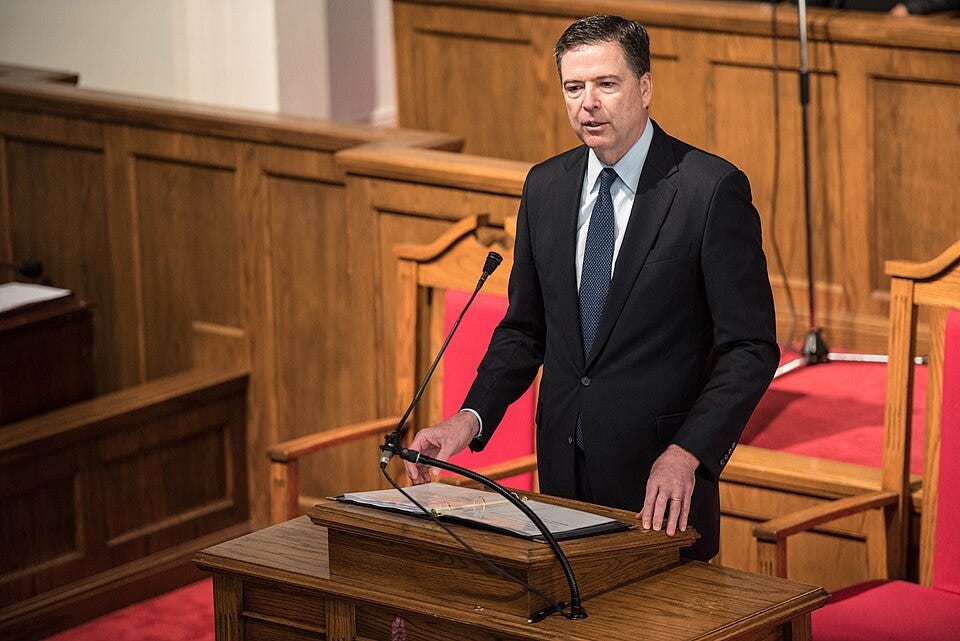 Stop Trump from labeling millions of Americans as domestic terrorists. Image of James Comey speaking at a conference