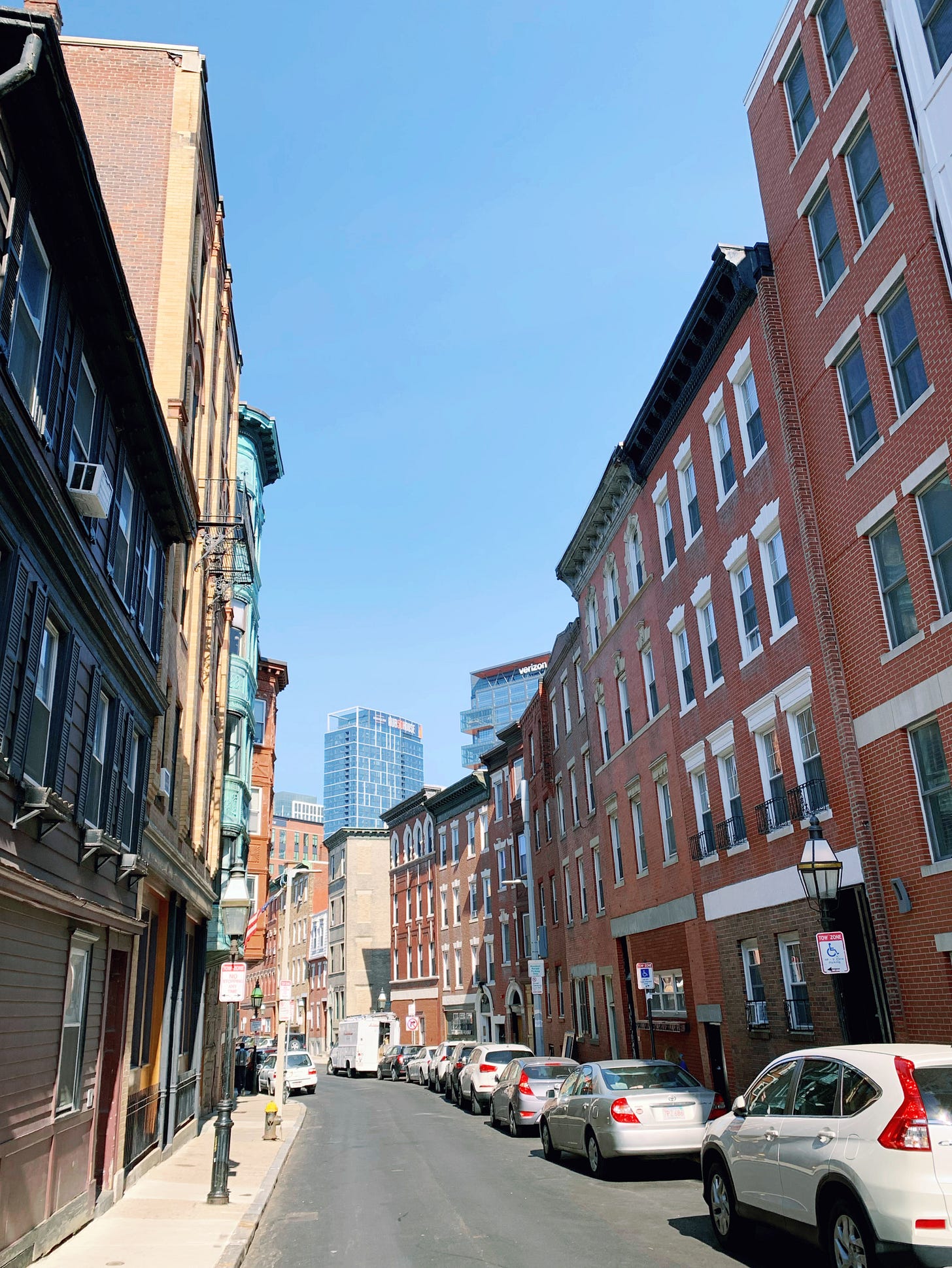 Street in North End with modern glass building in the background