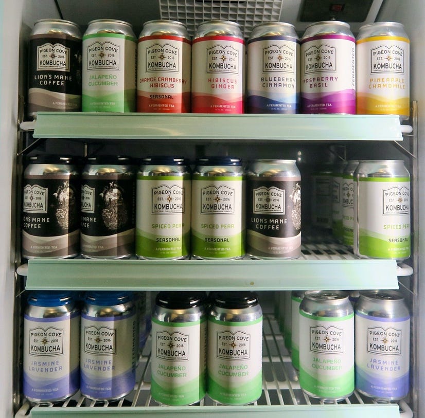 A shelf of drinks in a refrigerator

Description automatically generated