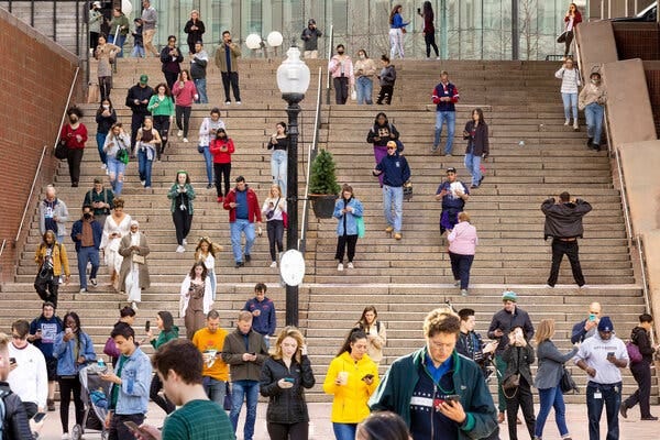 A composite of photos taken at Government Center, Boston, over about an hour in March 2022, showing only people with their phones. A composite of photos taken at Government Center, Boston, over about an hour in March 2022, showing only people with their phones.